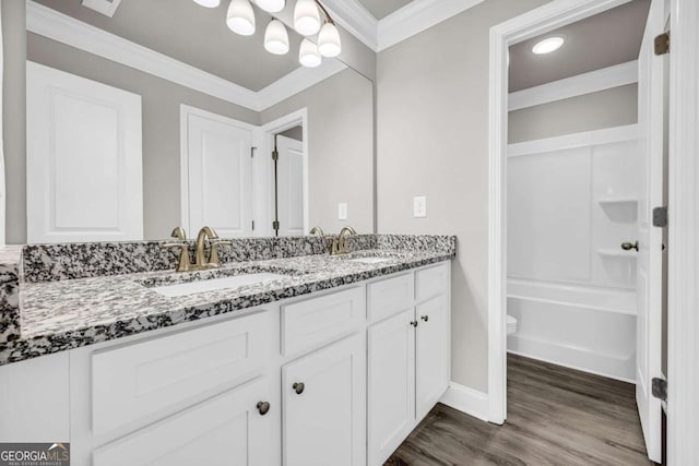 full bathroom featuring shower / bath combination, vanity, crown molding, wood-type flooring, and toilet