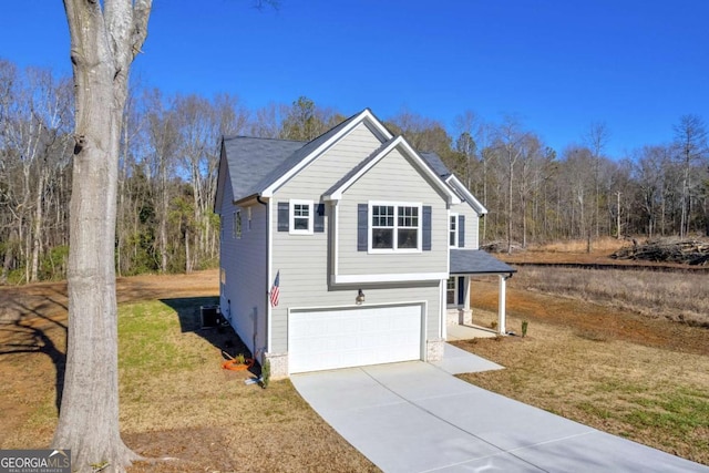 view of front of home with a front yard and a garage