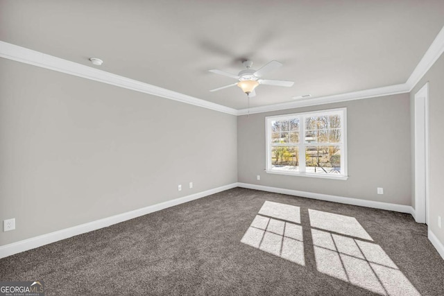 empty room with dark colored carpet, ceiling fan, and ornamental molding