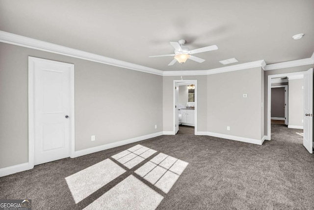 unfurnished bedroom featuring dark colored carpet, ceiling fan, crown molding, and connected bathroom