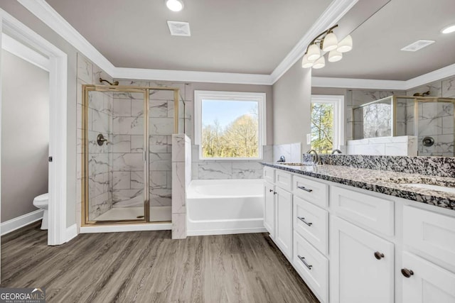 full bathroom featuring vanity, crown molding, hardwood / wood-style flooring, toilet, and independent shower and bath