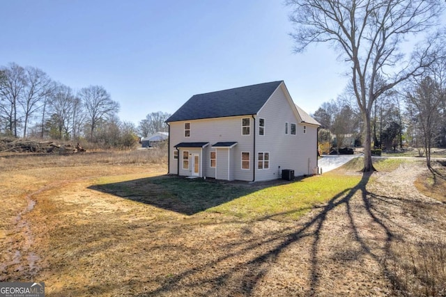 view of property exterior featuring a yard and central AC