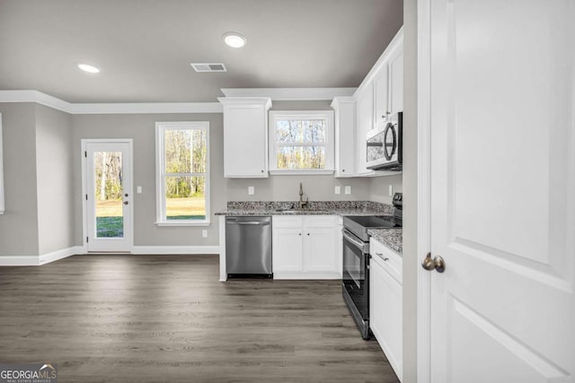 kitchen featuring dark wood-type flooring, white cabinets, sink, light stone countertops, and stainless steel appliances