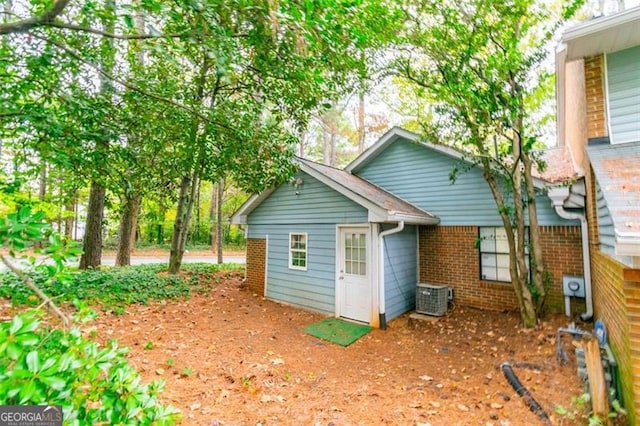 rear view of property with central AC unit