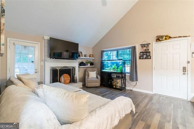 living room featuring dark hardwood / wood-style floors and vaulted ceiling