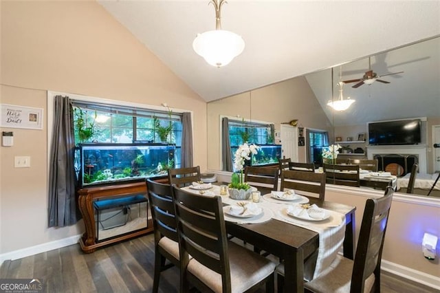 dining space with ceiling fan, dark wood-type flooring, and lofted ceiling