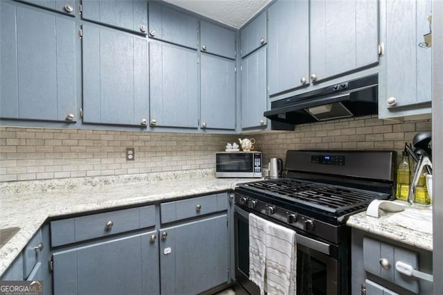 kitchen featuring decorative backsplash, light stone counters, and appliances with stainless steel finishes