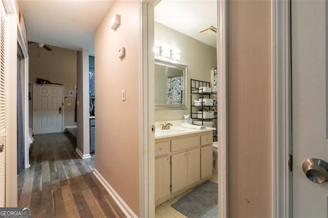 bathroom with vanity, hardwood / wood-style flooring, and toilet