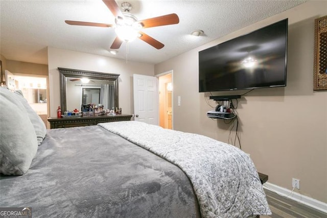 bedroom featuring ceiling fan, dark hardwood / wood-style floors, and a textured ceiling