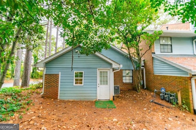 rear view of property featuring central air condition unit