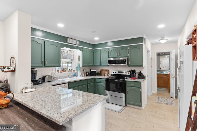 kitchen with kitchen peninsula, green cabinets, and appliances with stainless steel finishes