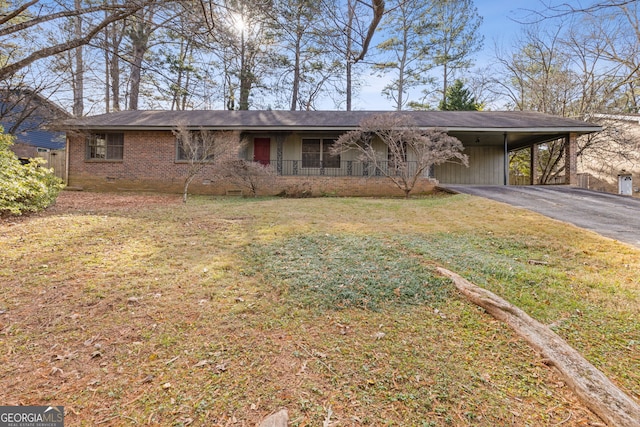 ranch-style home with a front yard, a carport, and covered porch