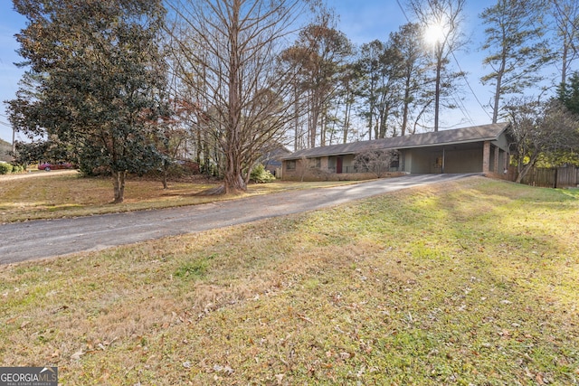 ranch-style house with a front lawn and a carport