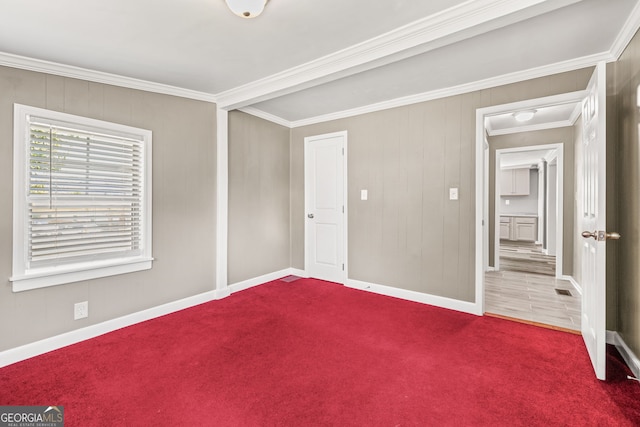 unfurnished room with carpet floors and crown molding