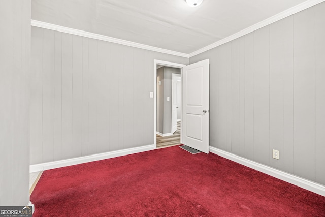 spare room with crown molding and carpet