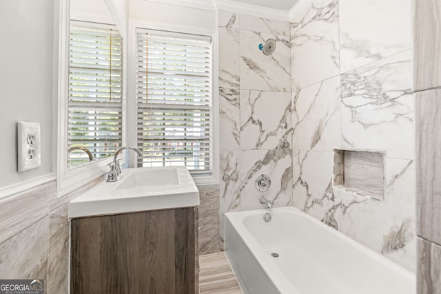 bathroom with ornamental molding, vanity, tile walls, and a healthy amount of sunlight