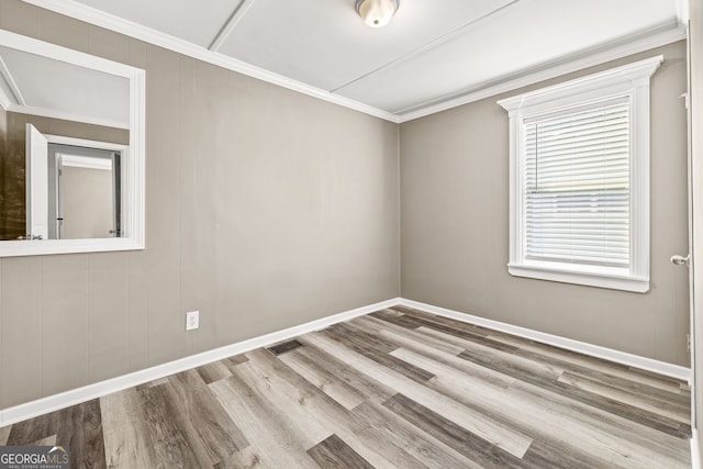 unfurnished room featuring light hardwood / wood-style floors and ornamental molding