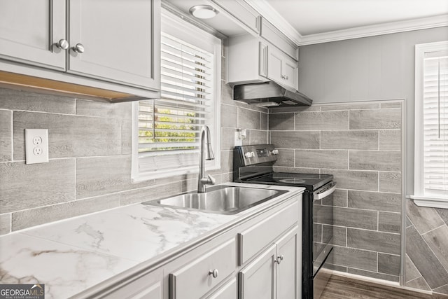 kitchen with dark wood-type flooring, sink, light stone countertops, ornamental molding, and black range with electric cooktop