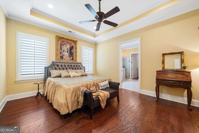 bedroom with ceiling fan, dark hardwood / wood-style flooring, a raised ceiling, and ornamental molding