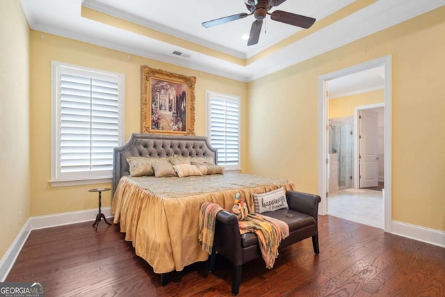 bedroom with a tray ceiling, multiple windows, ceiling fan, and dark hardwood / wood-style flooring