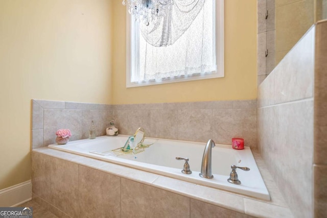 bathroom with a relaxing tiled tub