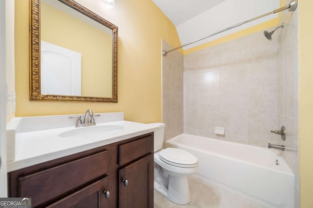 full bathroom with tile patterned floors, tiled shower / bath combo, vanity, toilet, and lofted ceiling