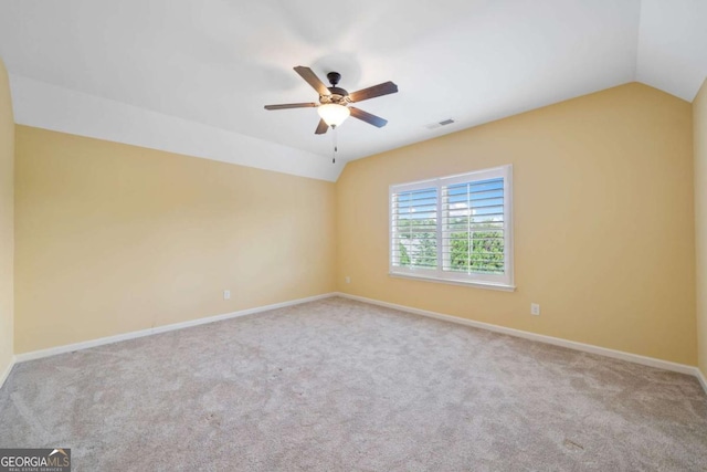 carpeted empty room with ceiling fan and lofted ceiling