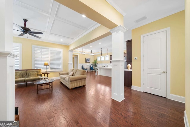 living room featuring coffered ceiling, crown molding, ceiling fan, beam ceiling, and decorative columns