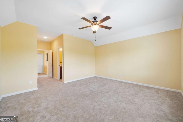 carpeted empty room with ceiling fan and lofted ceiling