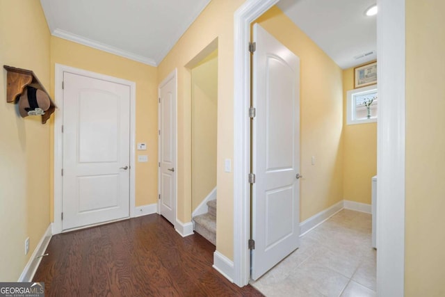 hallway featuring light hardwood / wood-style floors and ornamental molding