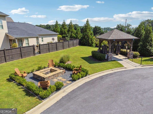 view of yard featuring a gazebo and a fire pit