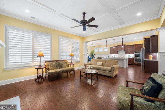 living room featuring coffered ceiling, sink, ceiling fan, dark hardwood / wood-style flooring, and decorative columns