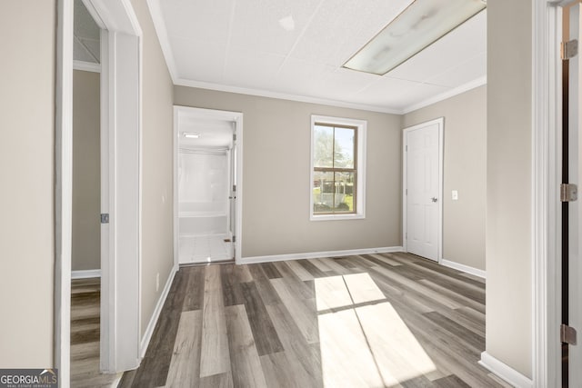 interior space with hardwood / wood-style floors and ornamental molding