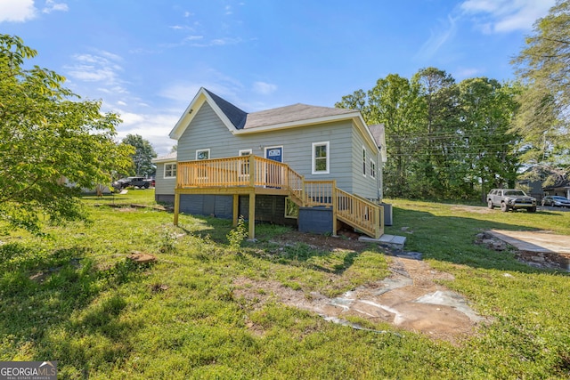 back of property with a yard and a wooden deck