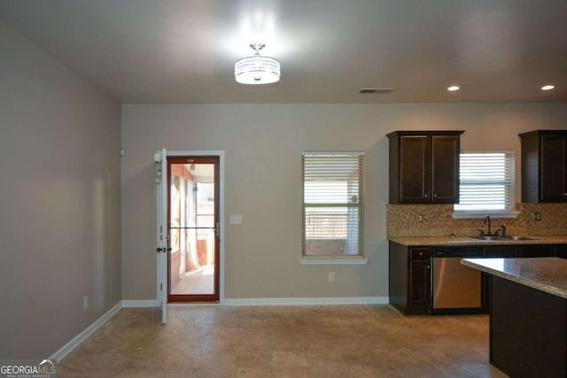 kitchen featuring tasteful backsplash, dark brown cabinetry, dishwasher, and sink