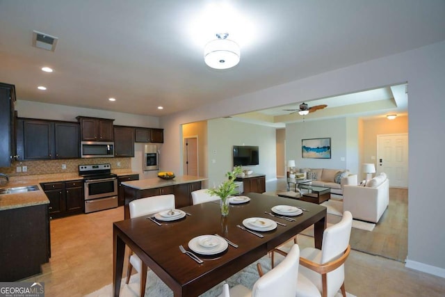 dining area featuring ceiling fan and sink