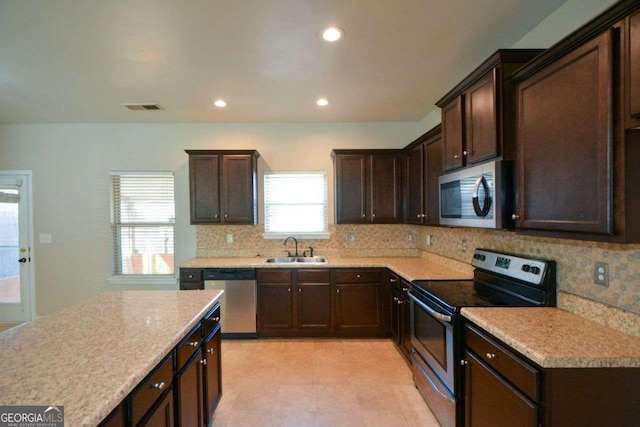 kitchen with a healthy amount of sunlight, sink, appliances with stainless steel finishes, and tasteful backsplash