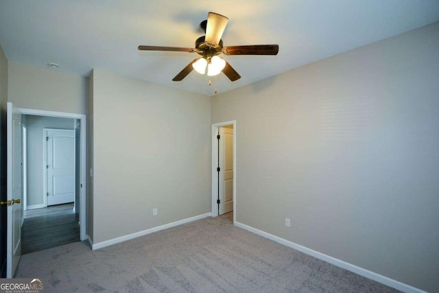 carpeted empty room featuring ceiling fan