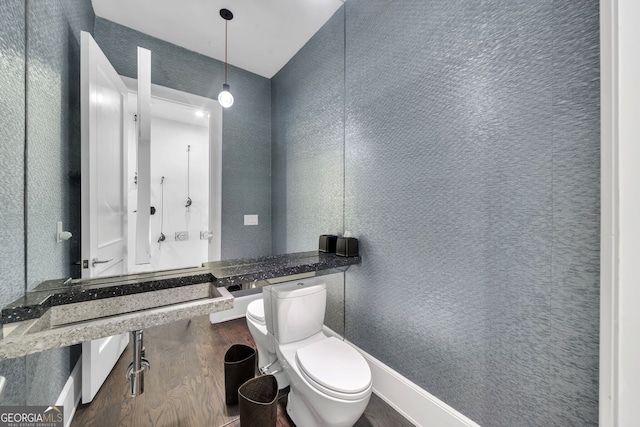 bathroom featuring wood-type flooring and toilet