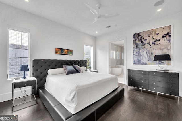 bedroom featuring ensuite bath, ceiling fan, dark hardwood / wood-style flooring, and multiple windows