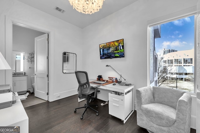 office with a chandelier and dark hardwood / wood-style floors