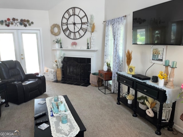 carpeted living room with a tiled fireplace