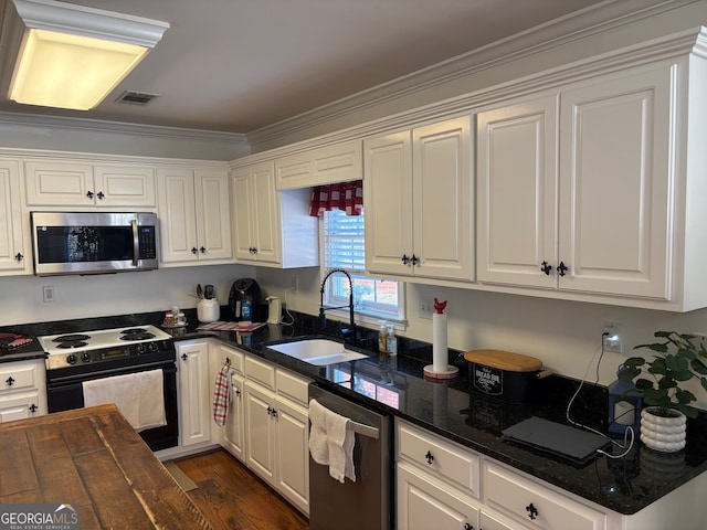 kitchen featuring white cabinets, sink, ornamental molding, and stainless steel appliances