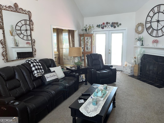 living room featuring vaulted ceiling, carpet floors, a fireplace, and french doors