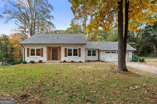 ranch-style house with a garage and a front lawn