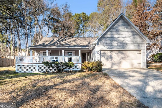 view of front of home featuring a front yard, a porch, and a garage