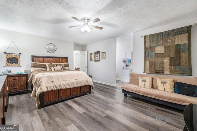 bedroom featuring wood-type flooring, a textured ceiling, and ceiling fan