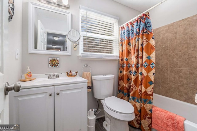 full bathroom with shower / tub combo with curtain, vanity, and toilet