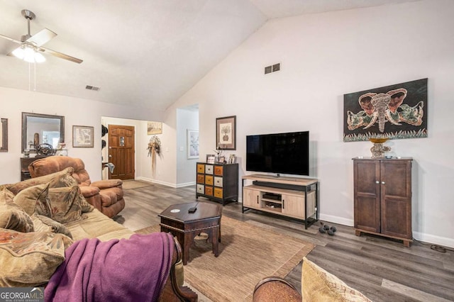 living room with hardwood / wood-style floors, ceiling fan, and high vaulted ceiling