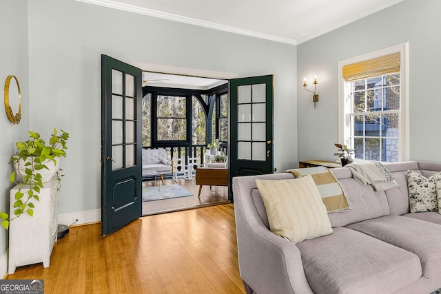 living room featuring a wealth of natural light, french doors, hardwood / wood-style floors, and ornamental molding